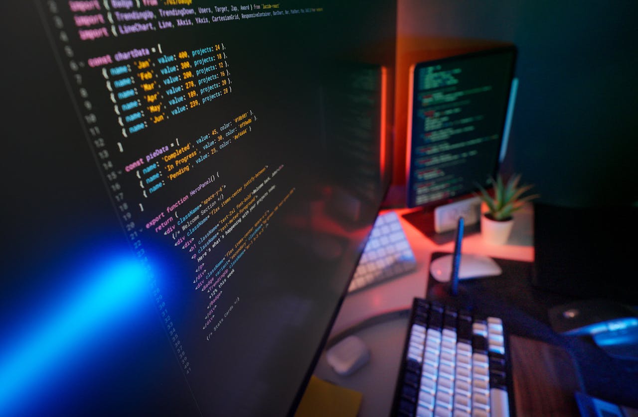 Services A vibrant workspace featuring colorful code on computer monitors, ideal for developers.